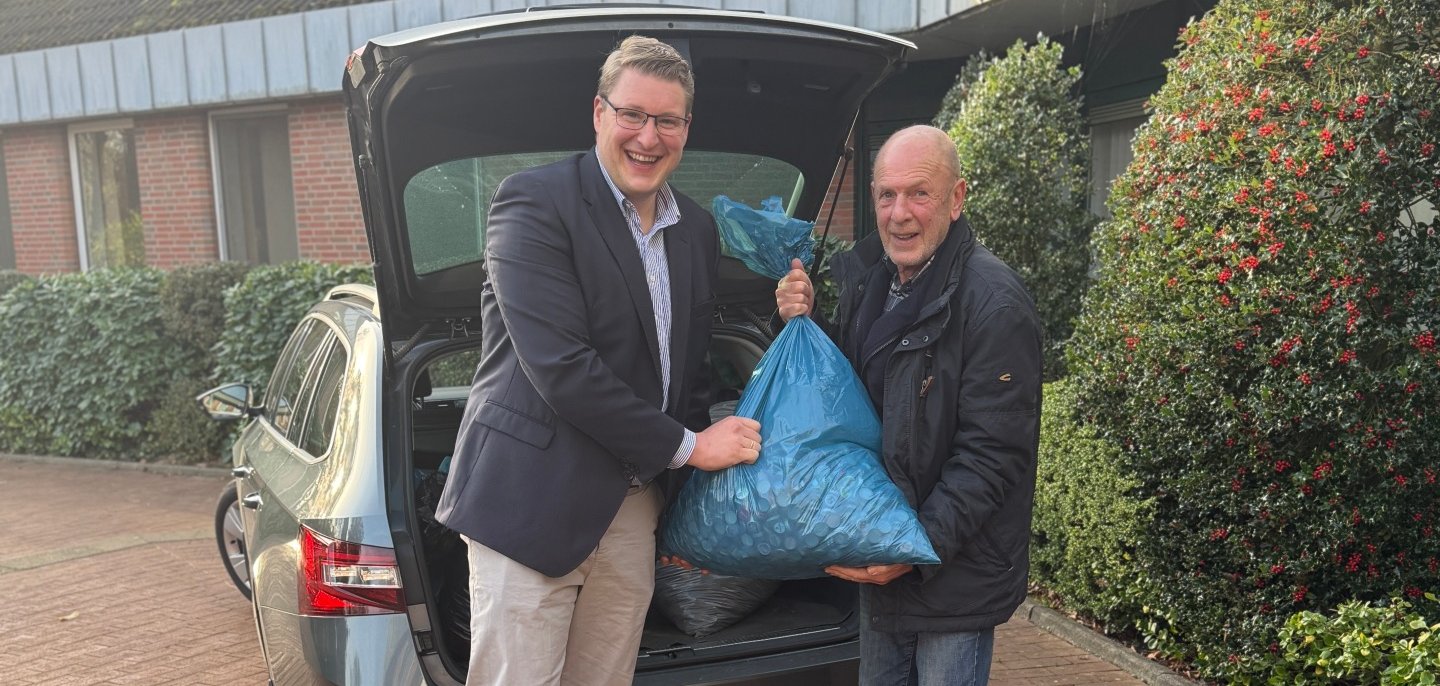 Bürgermeister Henrik Wärner und Initiator Udo Kawaletz laden die ersten Säcke voller Kronkorken ein.